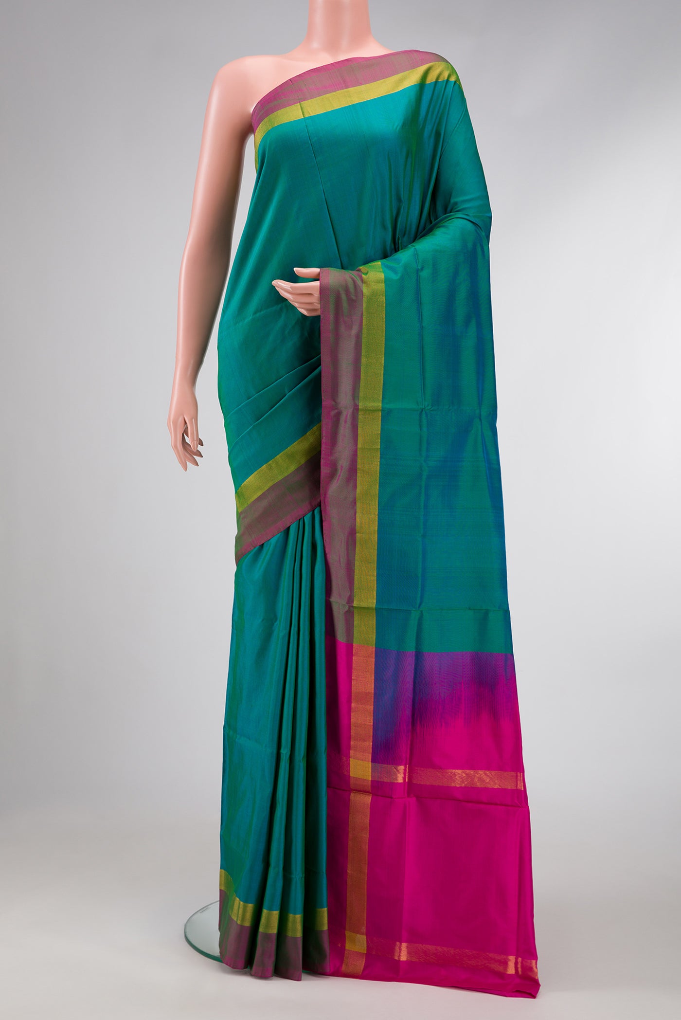 Peacock Blue Dual Tone Uppada Silk Saree with Plain Body and Zari Border.  displayed on a mannequin