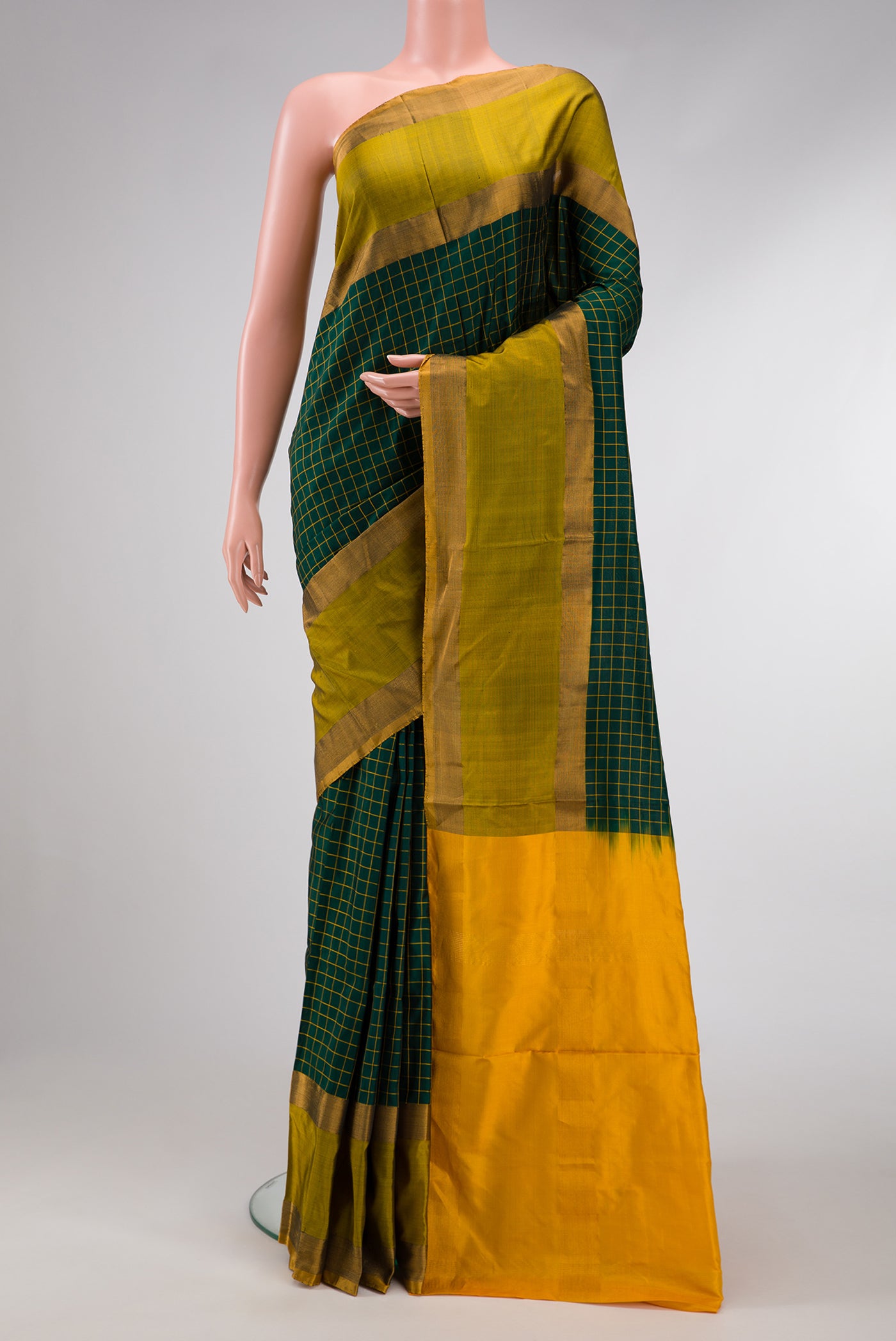 Green Dual Tone Soft Silk Saree with Zari Butta on the body and Zari Border.  displayed on a mannequin