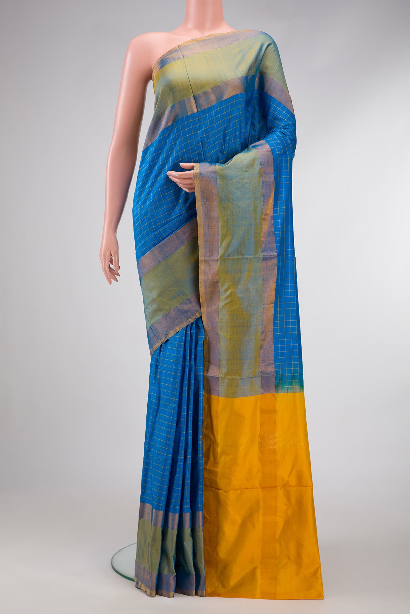 Peacock Blue Dual Tone Soft Silk Saree with Checked design on the body and Zari Border.  displayed on a mannequin