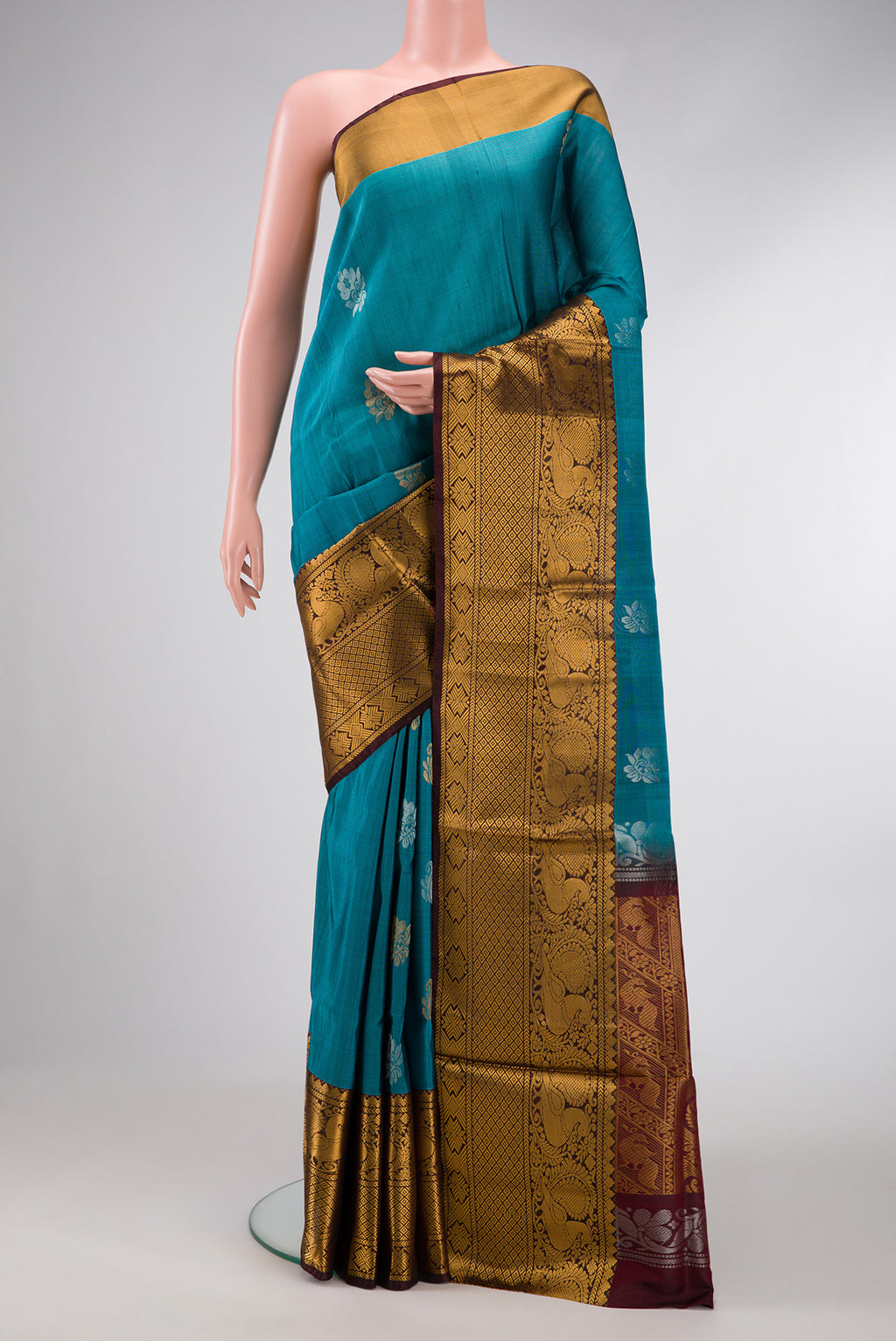 Peacock Blue Dual Tone Uppada Silk Saree with Zari Butta on the body and Zari Border.  displayed on a mannequin