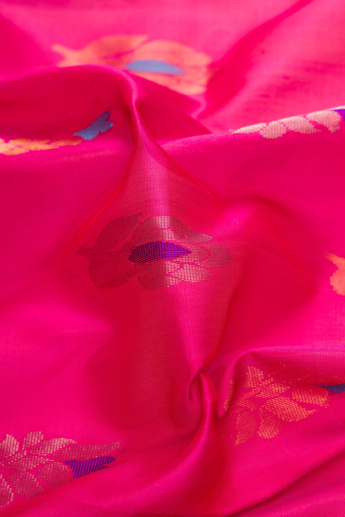 Close up of Pink Dual Tone Uppada Silk Saree with Zari And Thread Butta on the body and Zari Border.  displaying folds