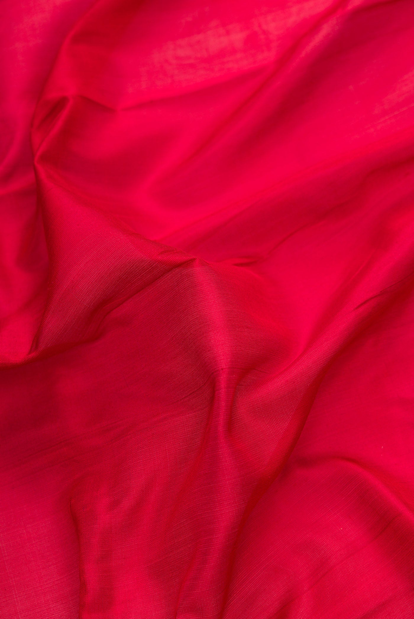 Close up of Maroon Dual Tone Uppada Silk Saree with Plain Body and Zari Border.  displaying folds