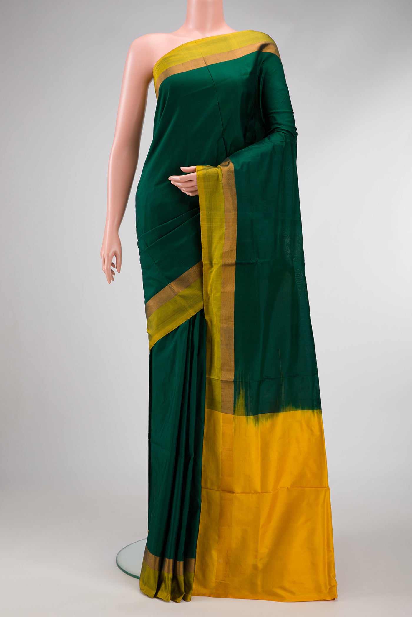 Green Dual Tone Uppada Silk Saree with Zari Butta on the body and Zari Border.  displayed on a mannequin