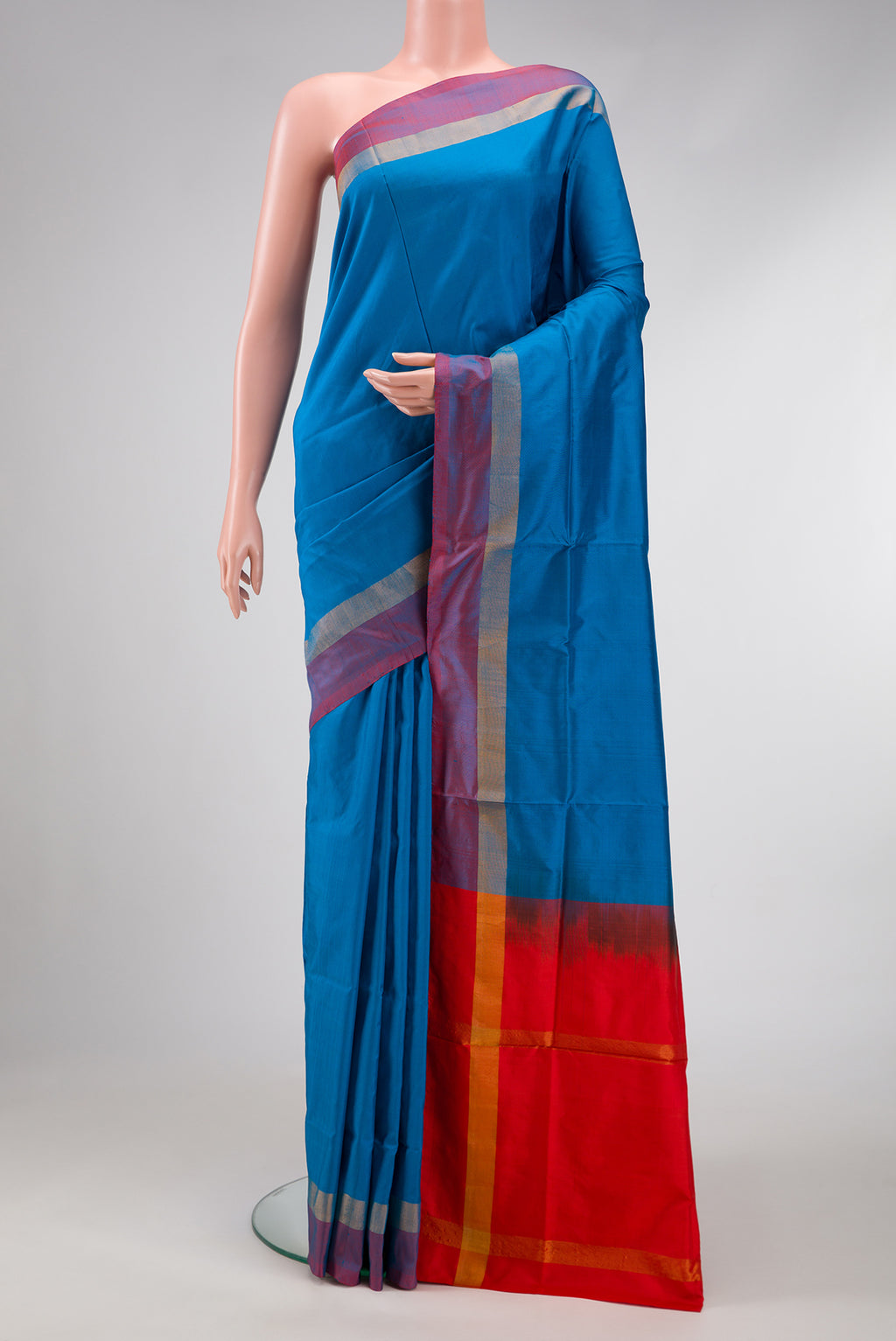 Peacock Blue Dual Tone Uppada Silk Saree with Plain Body and Zari Border.  displayed on a mannequin