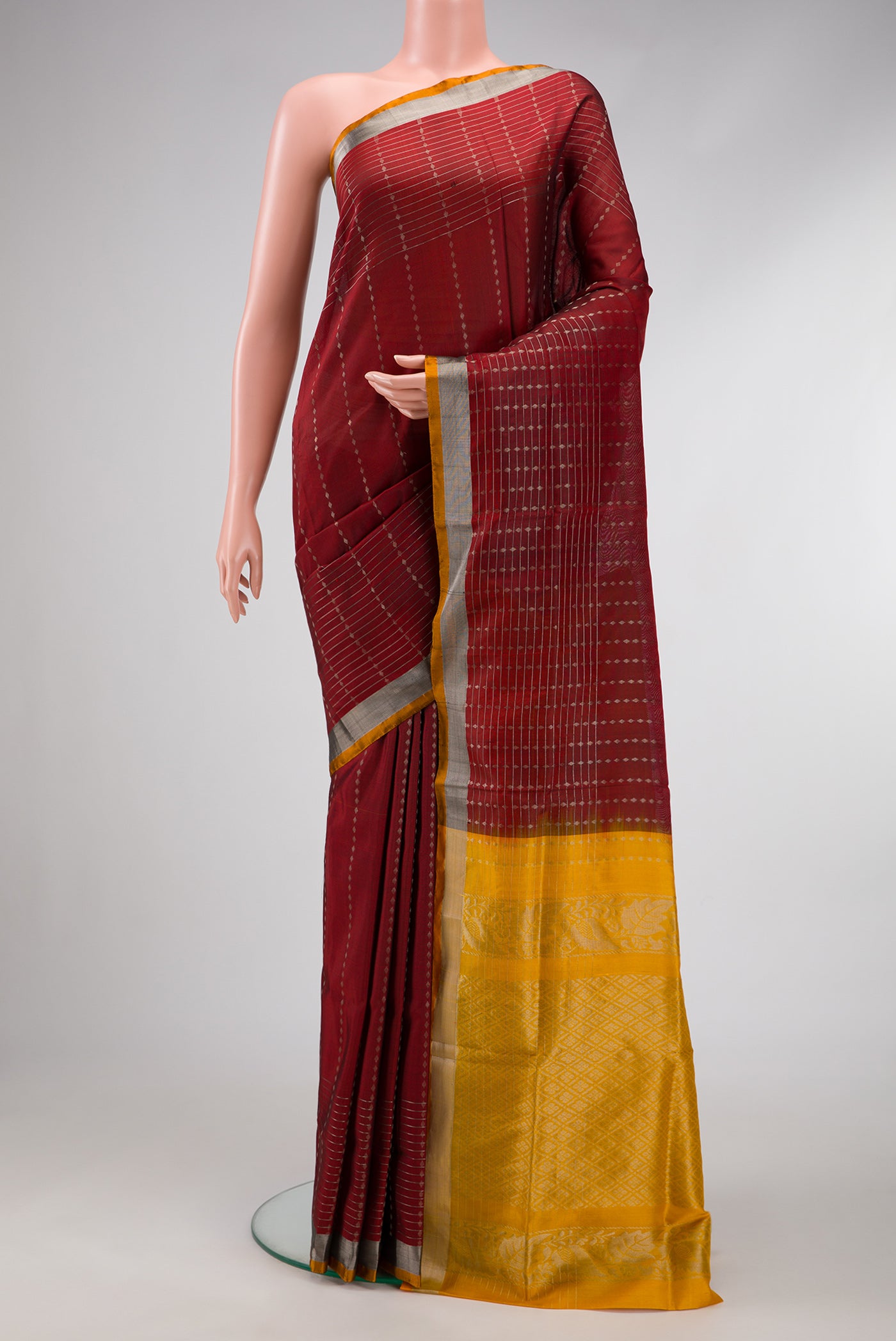 Maroon Dual Tone Uppada Silk Saree with Stripes on the body and Zari Border.  displayed on a mannequin
