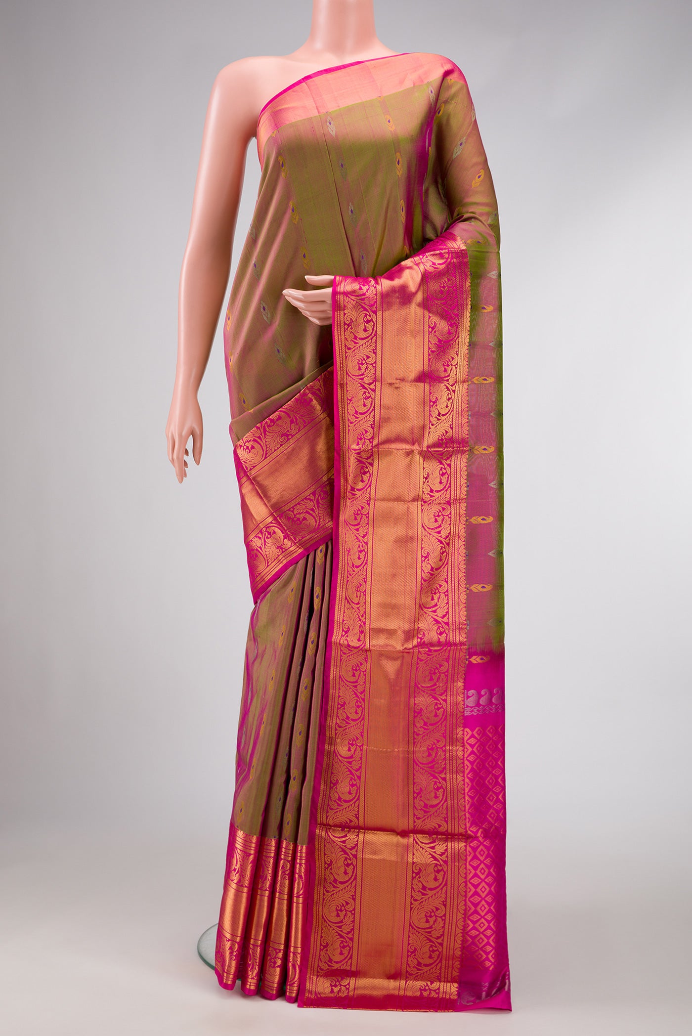 Green Dual Tone Uppada Silk Saree with Zari Butta on the body and Zari Border.  displayed on a mannequin