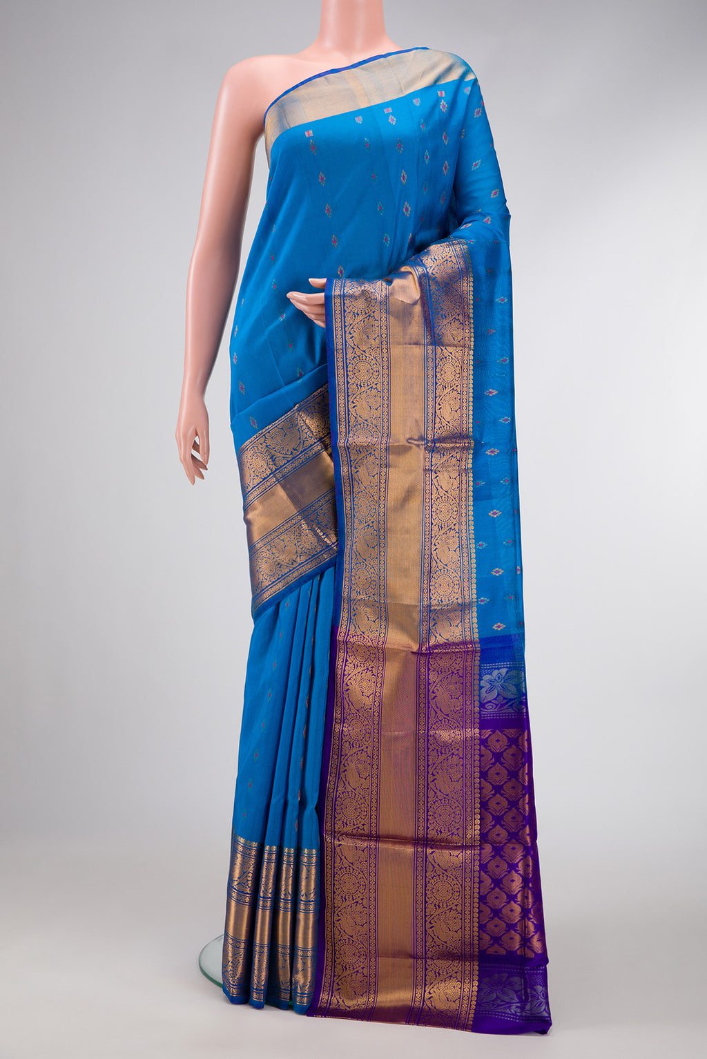 Sky Blue Dual Tone Uppada Silk Saree with Zari And Thread Butta on the body and Zari Border.  displayed on a mannequin