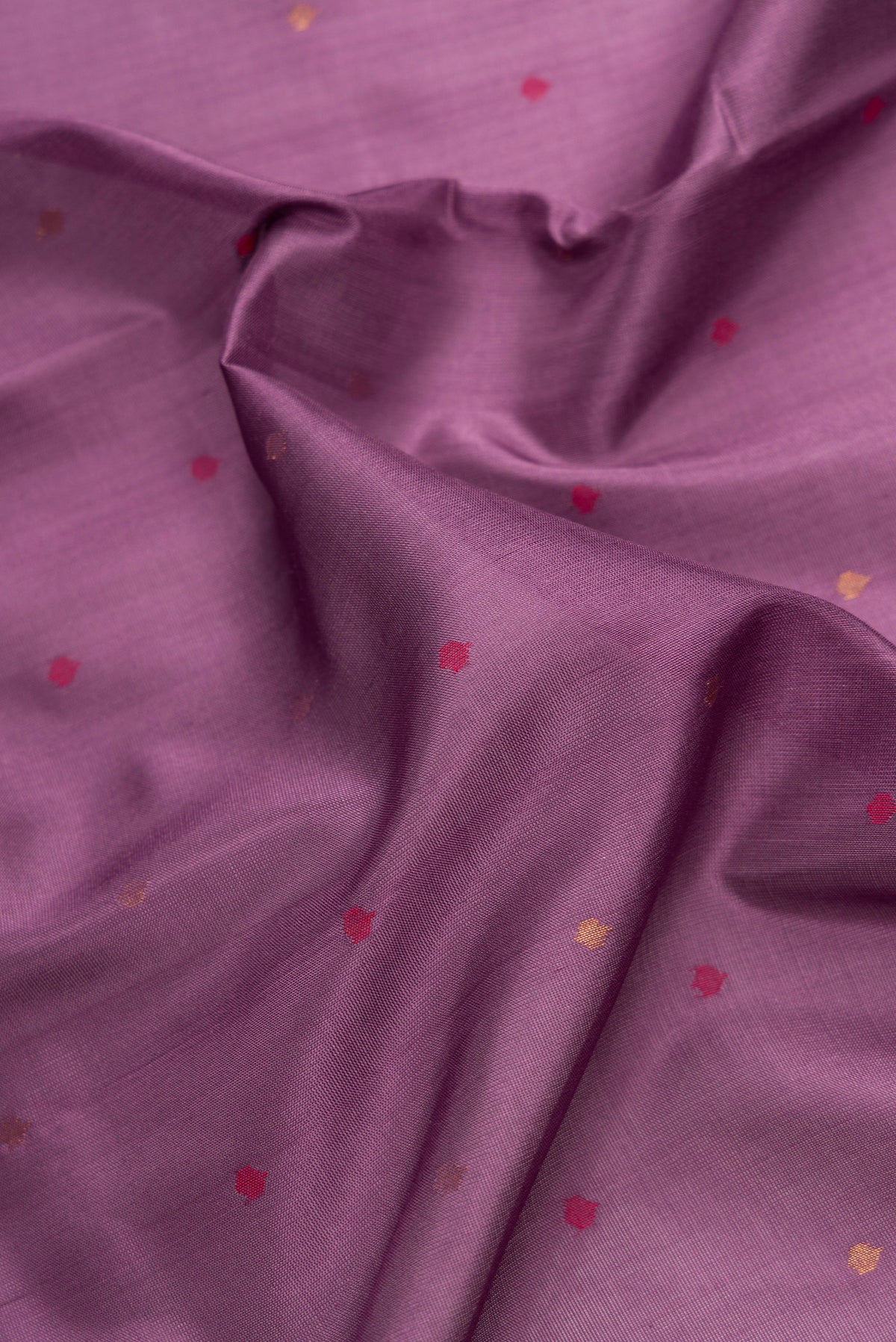 Close up of Lavender Dual Tone Uppada Silk Saree with Zari And Thread Butta on the body and Zari Border.  displaying folds