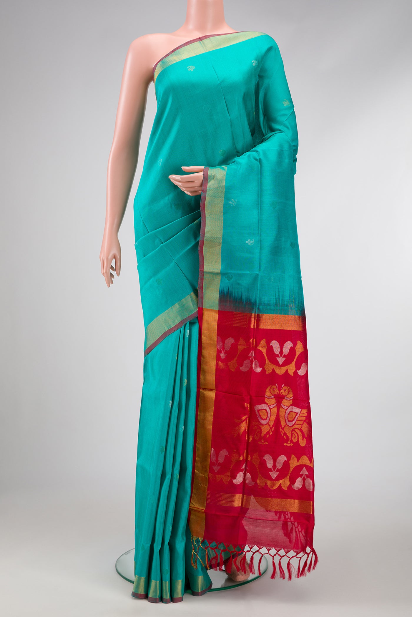 Sea Green Dual Tone Uppada Silk Saree with Zari Butta on the body and Zari Border.  displayed on a mannequin