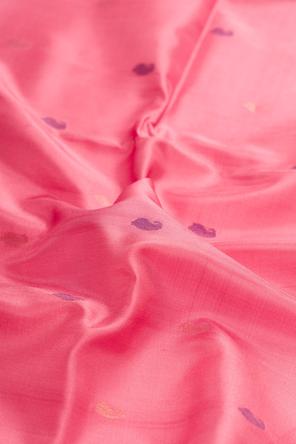Close up of Pink Dual Tone Uppada Silk Saree with Zari And Thread Butta on the body and Zari Border.  displaying folds