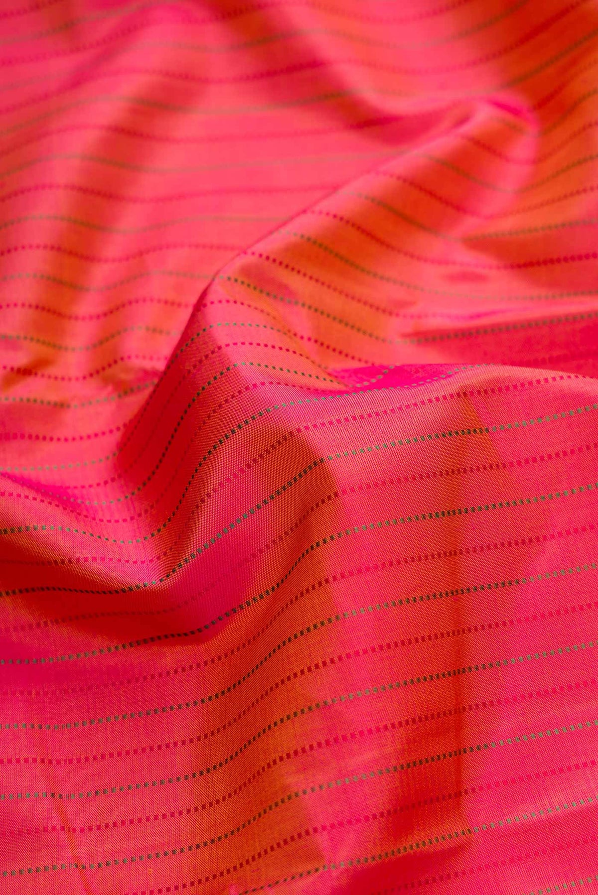 Close up of Dark Mauve Dual Tone Kanchipuram Silk Saree with Stripes on the body and Zari Border.  displaying folds