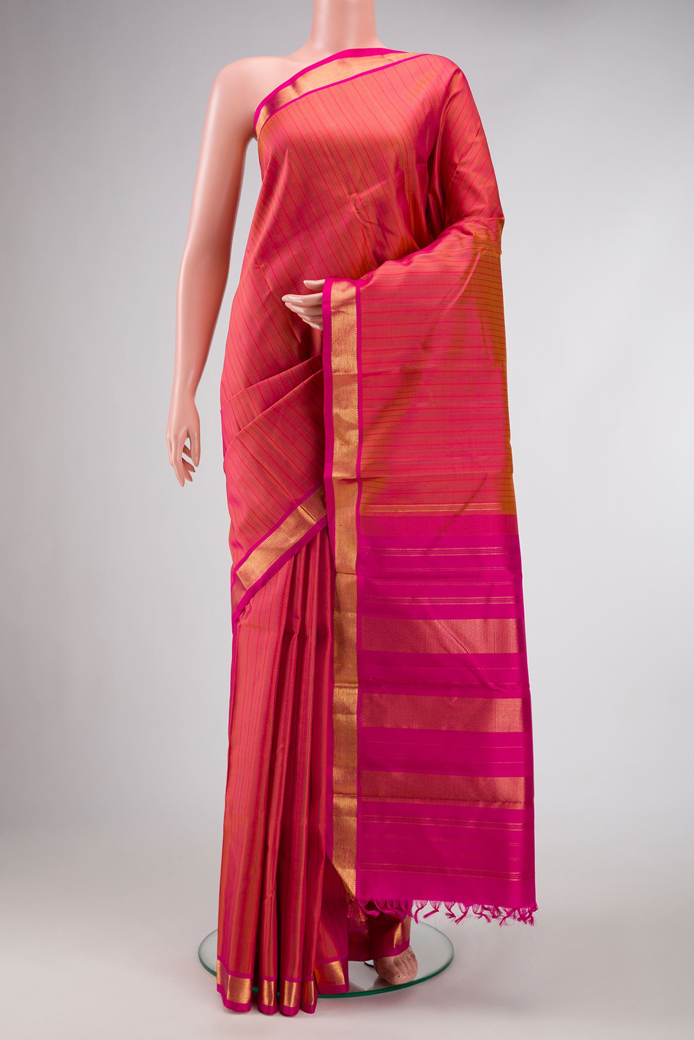 Dark Mauve Dual Tone Kanchipuram Silk Saree with Stripes on the body and Zari Border.  displayed on a mannequin