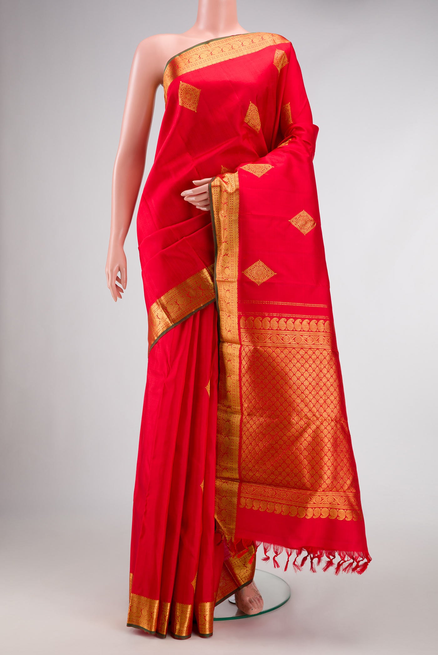 Red Dual Tone Kanjivaram Silk Saree with Zari Butta on the body and Zari Border.  displayed on a mannequin