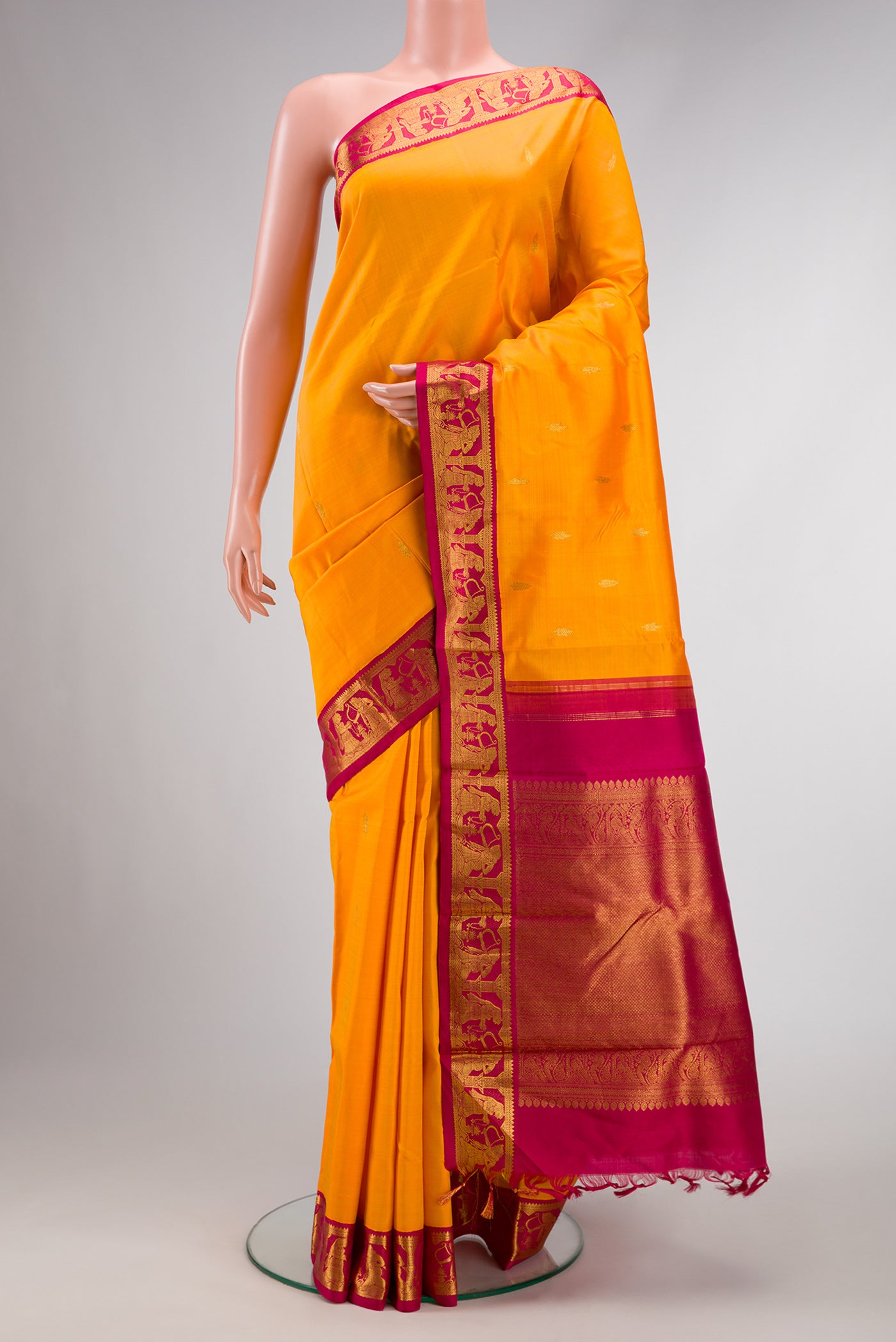 Pure Silk Pure Zari Orange Dual Tone Kanjivaram Saree with Zari Butta on the body and Zari Border.  displayed on a mannequin