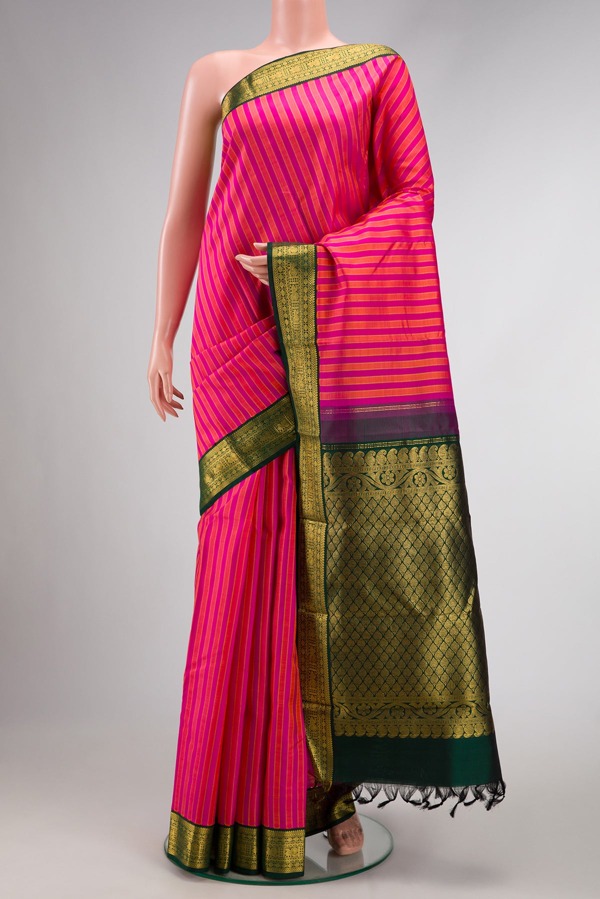 Pink Dual Tone Kanjivaram Silk Saree with Stripes on the body and Zari Border.  displayed on a mannequin