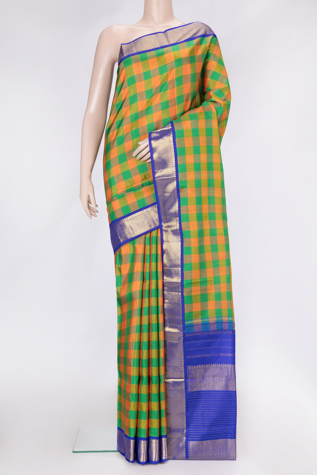Green and Orange Color Kanjivaram Silk Saree with Checked design on the body and Zari Border.  displayed on a mannequin