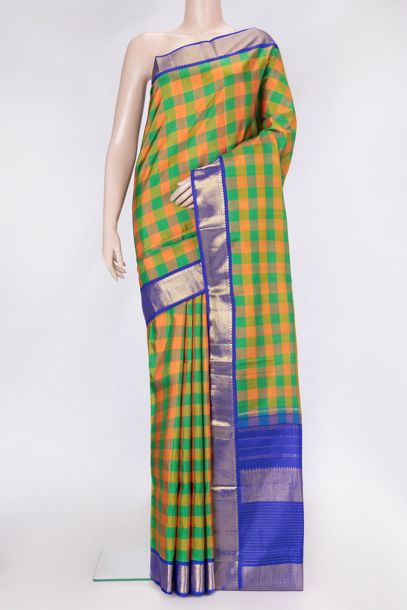 Green and Orange Color Kanjivaram Silk Saree with Checked design on the body and Zari Border.  displayed on a mannequin