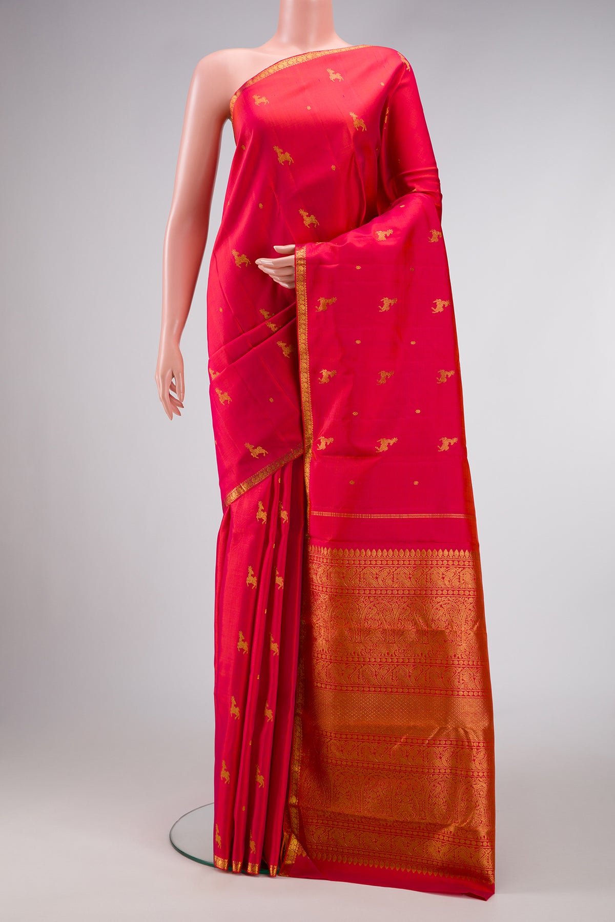 Red Dual Tone Kanjivaram Silk Saree with Zari Butta on the body and Zari Border.  displayed on a mannequin