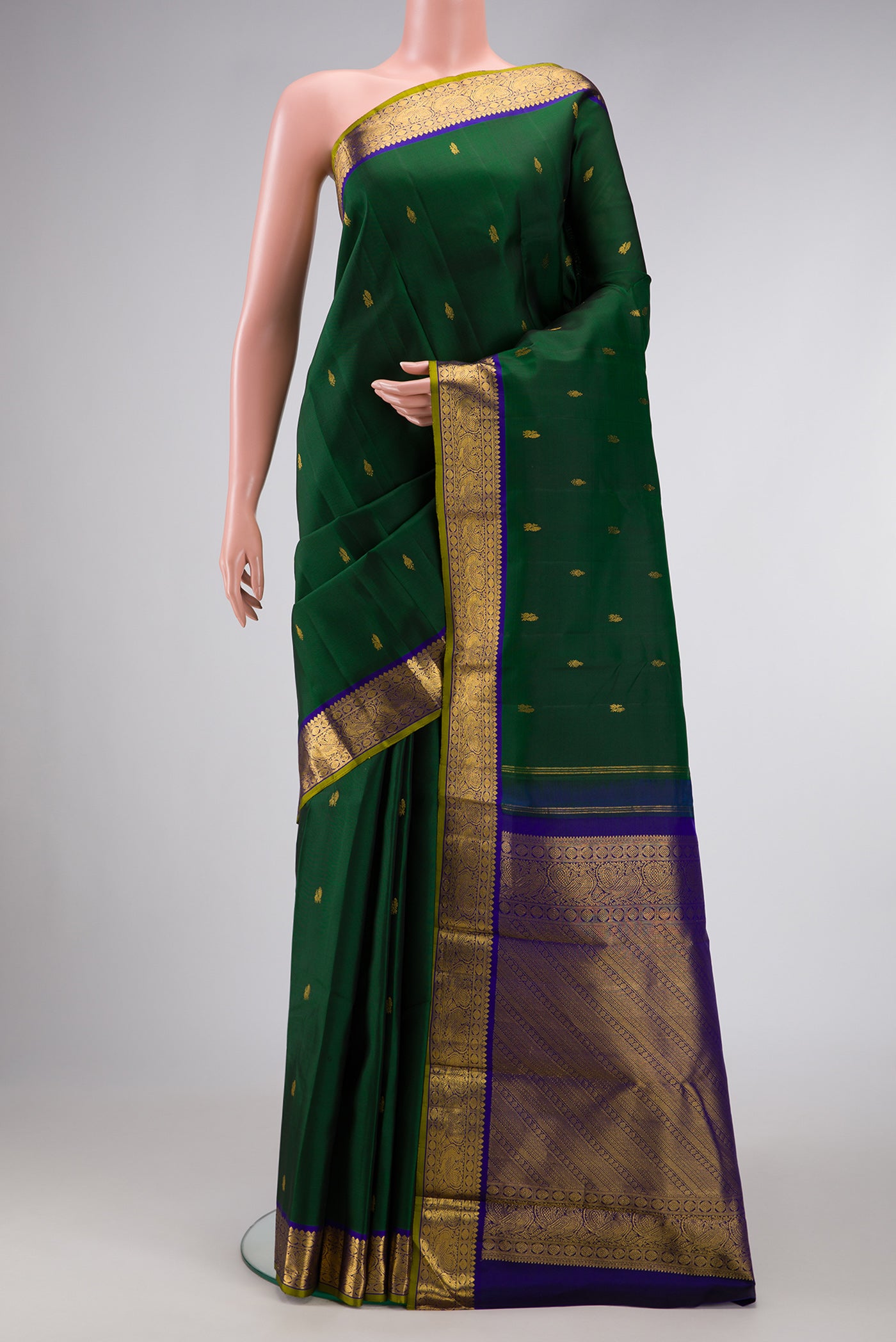 Bottle Green Dual Tone Kanchipuram Silk Saree with Zari Butta on the body and Zari Border.  displayed on a mannequin