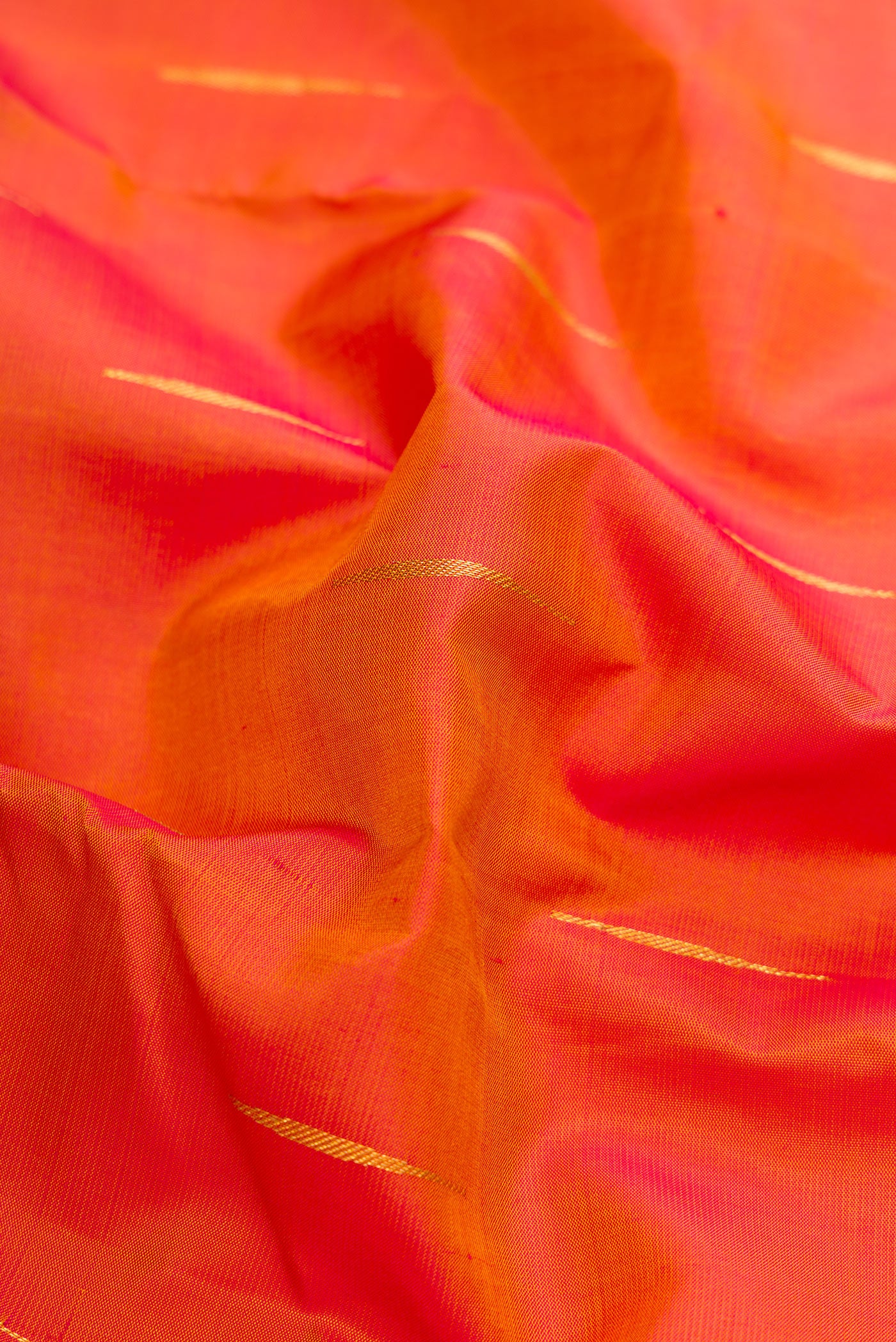 Close up of Mustard Dual Tone Kanchipuram Silk Saree with Zari Butta on the body and Zari Border.  displaying folds