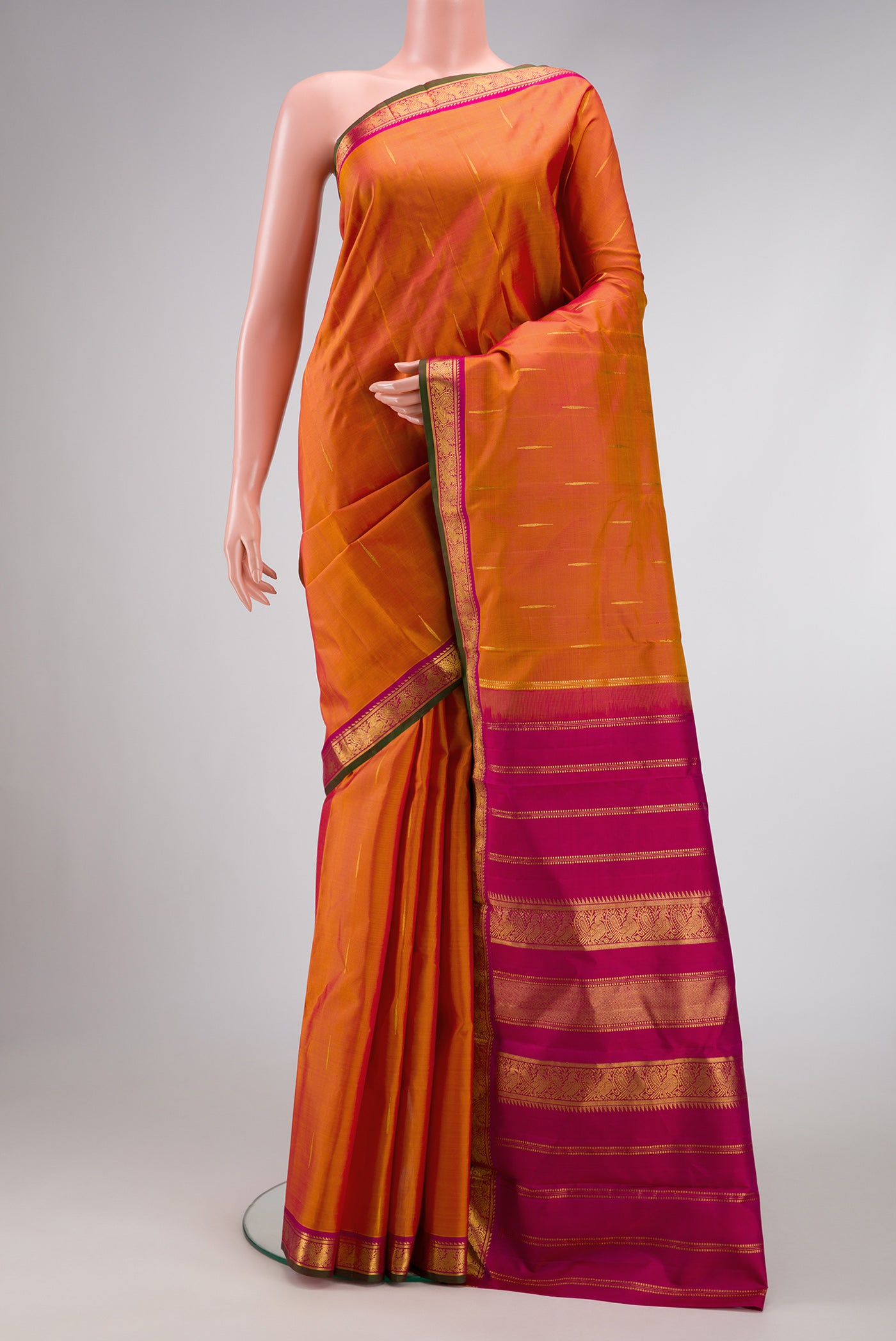 Mustard Dual Tone Kanchipuram Silk Saree with Zari Butta on the body and Zari Border.  displayed on a mannequin