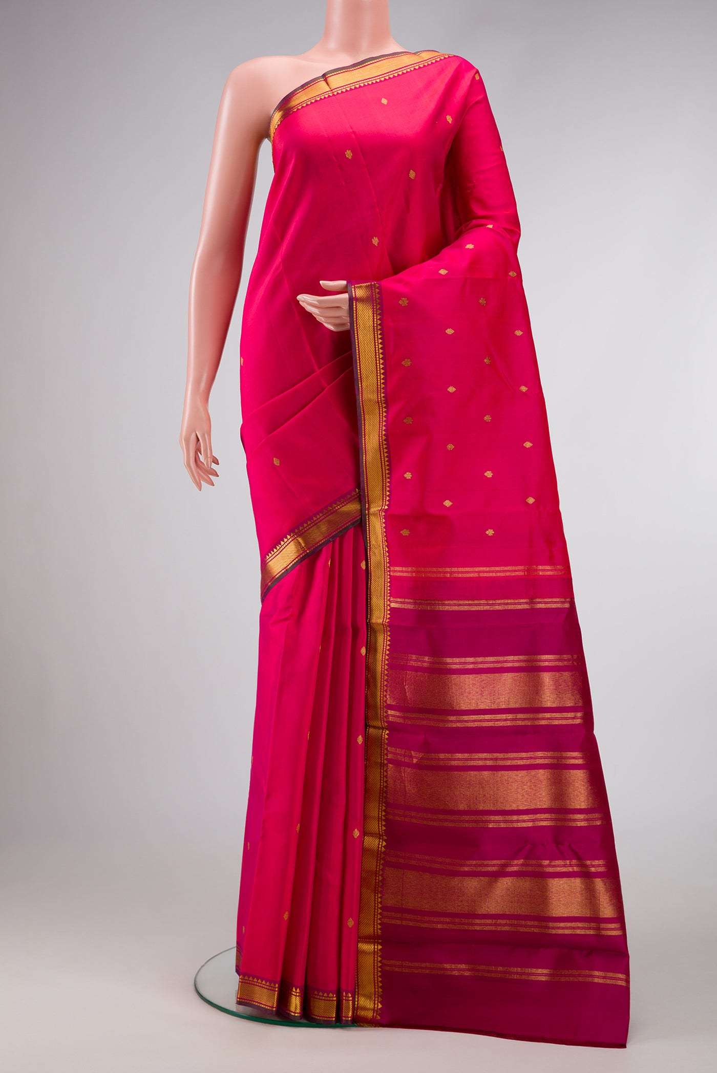 Dark Pink Dual Tone Kanchipuram Silk Saree with Zari Brocade on the body and Zari Border.  displayed on a mannequin