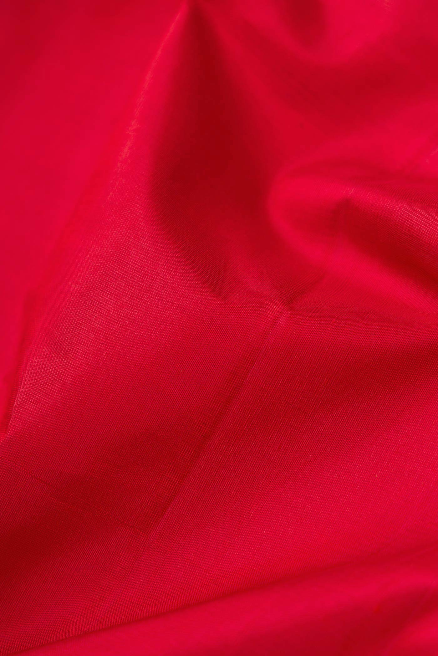 Close up of Maroon Dual Tone Kanjivaram Silk Saree with Plain Body and Zari Border.  displaying folds