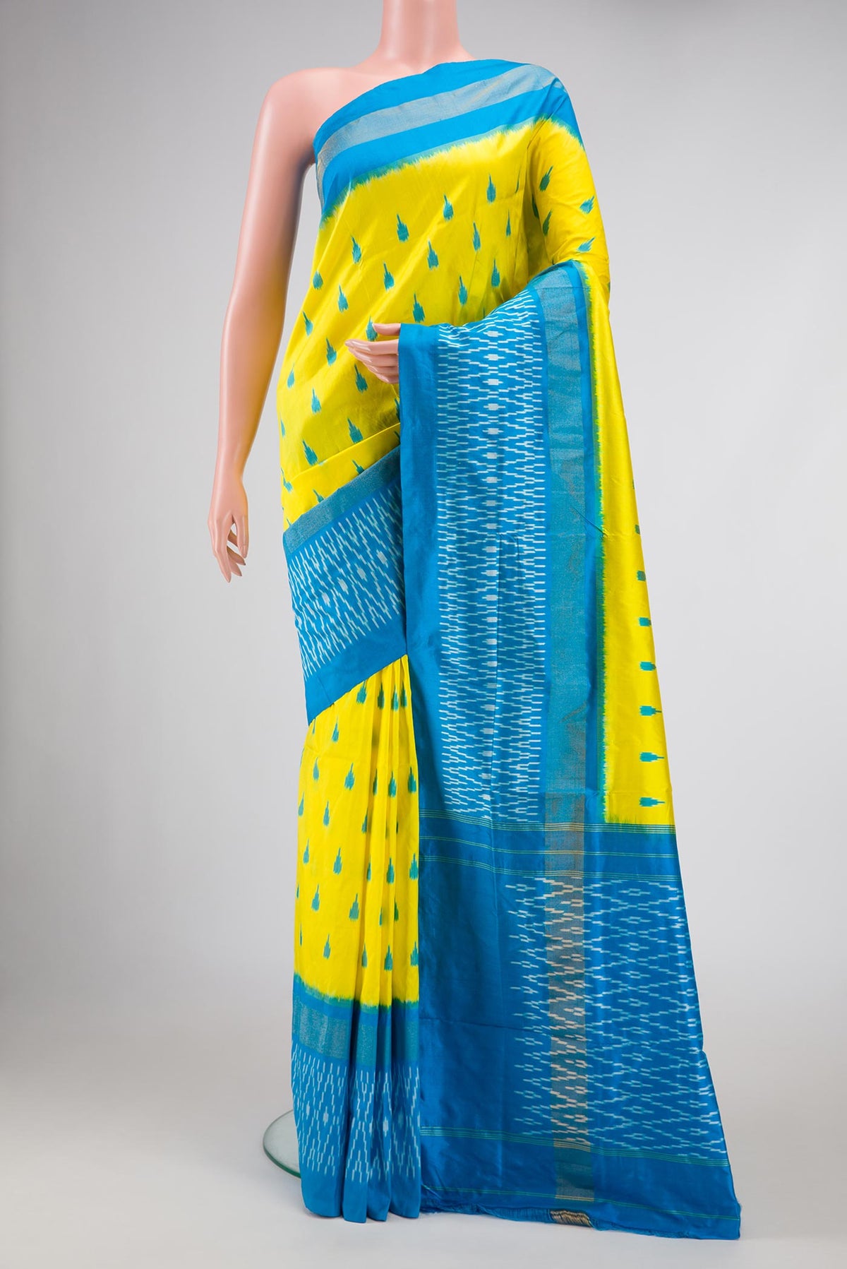 Lemon Yellow Pochampally Silk Saree with Pure Ikat on the body and Zari Border displayed on a mannequin