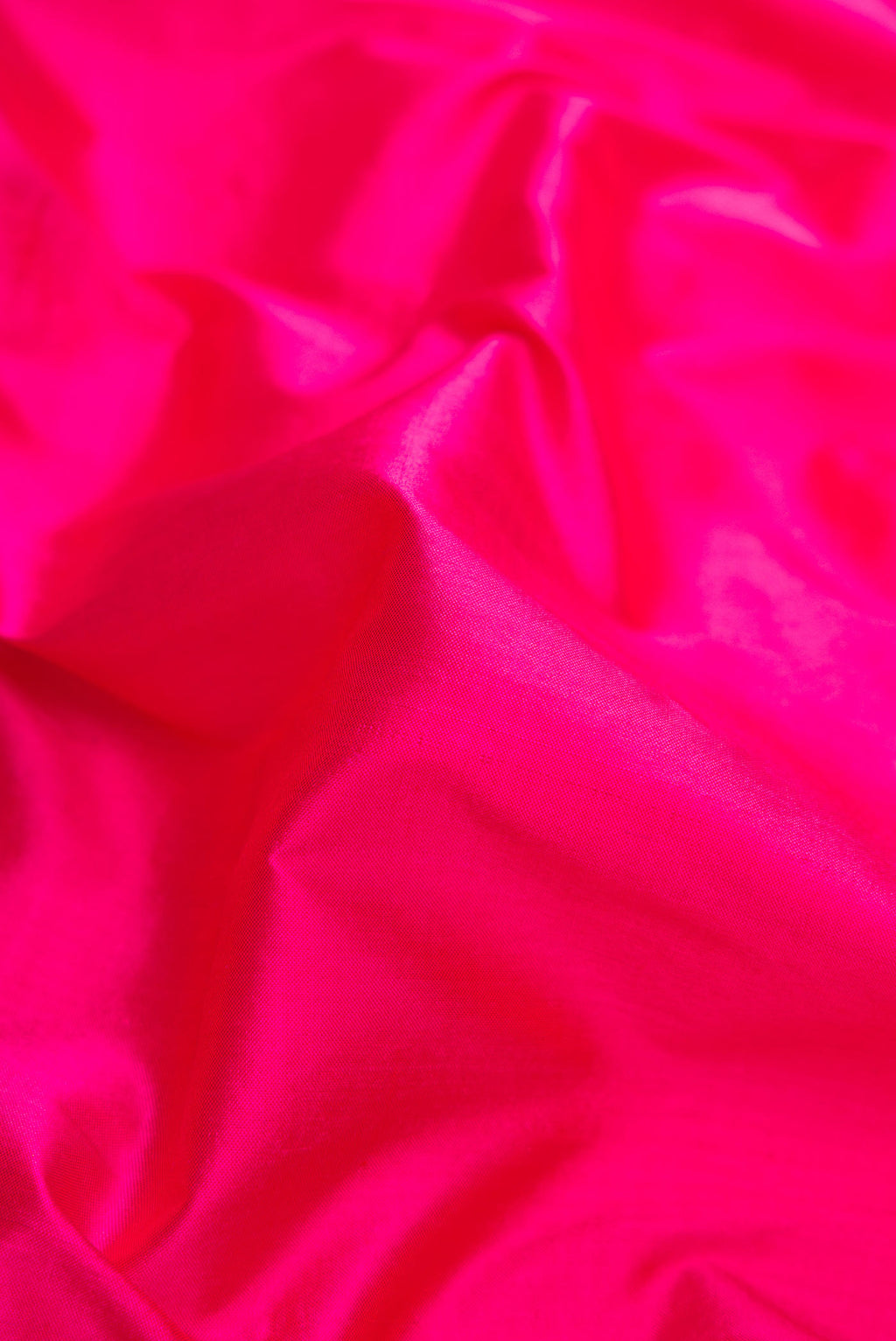 Close up of Pink Pochampally Silk Saree with Plain Body and Zari Border displaying folds