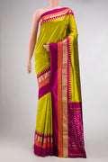 Parrot Green Dual Tone Double Ikat Saree with Plain Body and Zari Border.  displayed on a mannequin