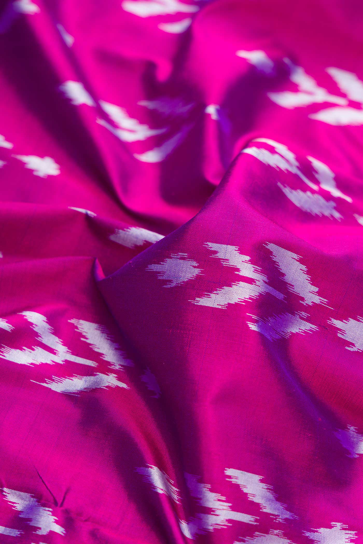 Close up of Purple Dual Tone Double Ikat Saree with Ikat Print on the body and Ikat Border displaying folds