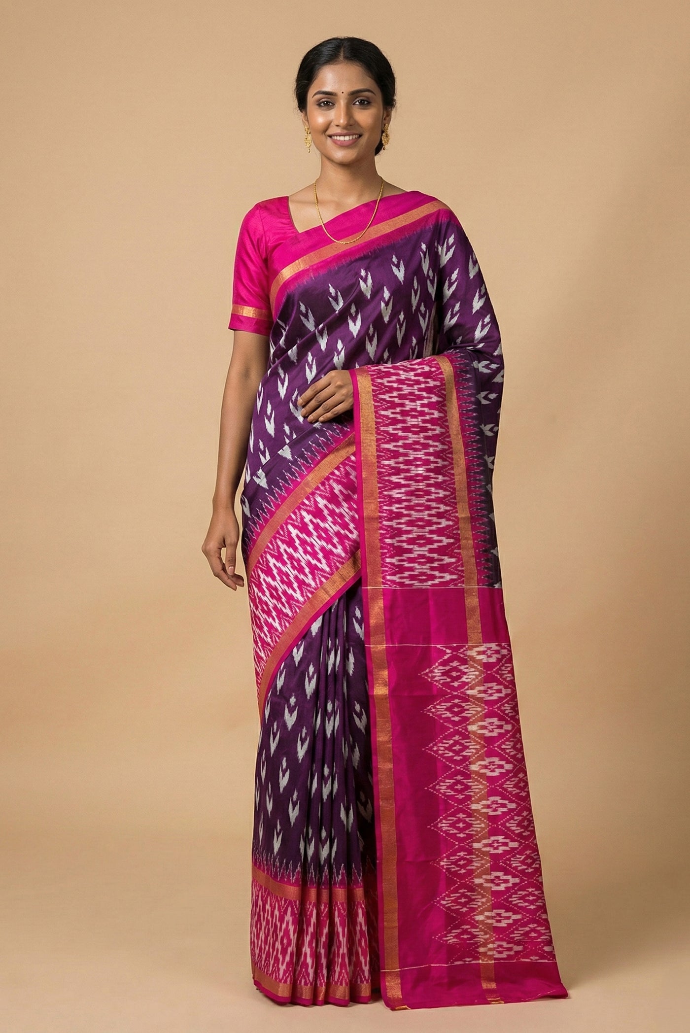 Model wearing a Purple Pochampally Silk Saree with Pure Ikat on the body and Ikat Border.