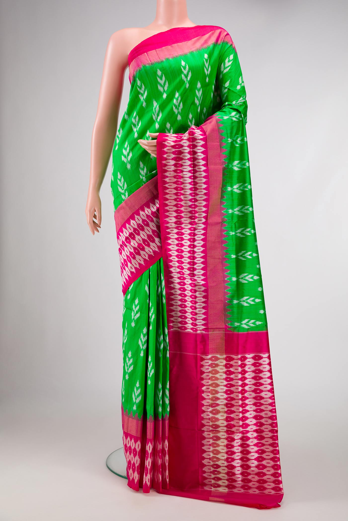 Green Dual Tone Double Ikat Saree with Ikat Print on the body and Ikat Border.  displayed on a mannequin