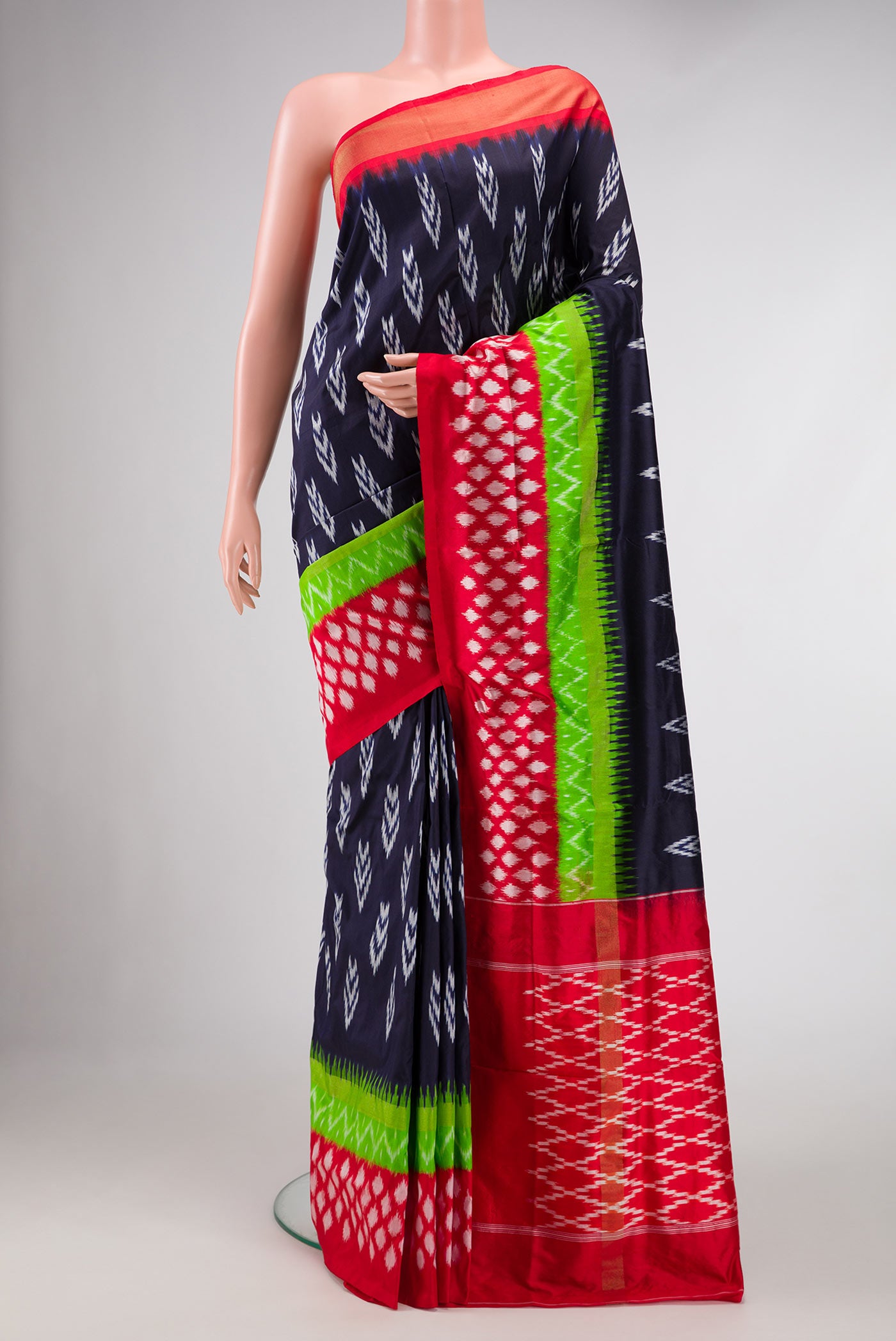 Navy Blue Dual Tone Double Ikat Saree with Ikat Print on the body and Ikat Border.  displayed on a mannequin