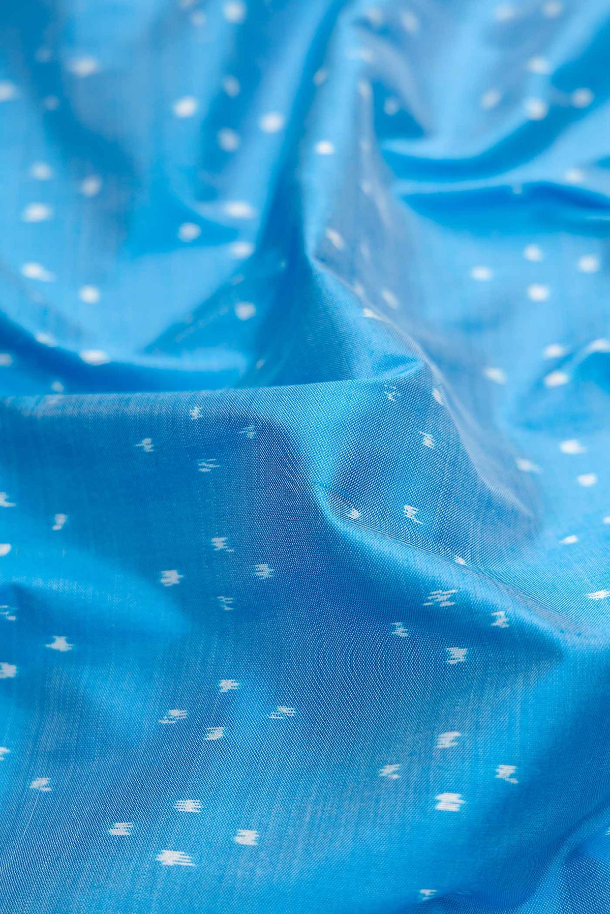 Close up of Sky Blue Pochampally Silk Saree with Pure Ikat on the body and Zari Border displaying folds