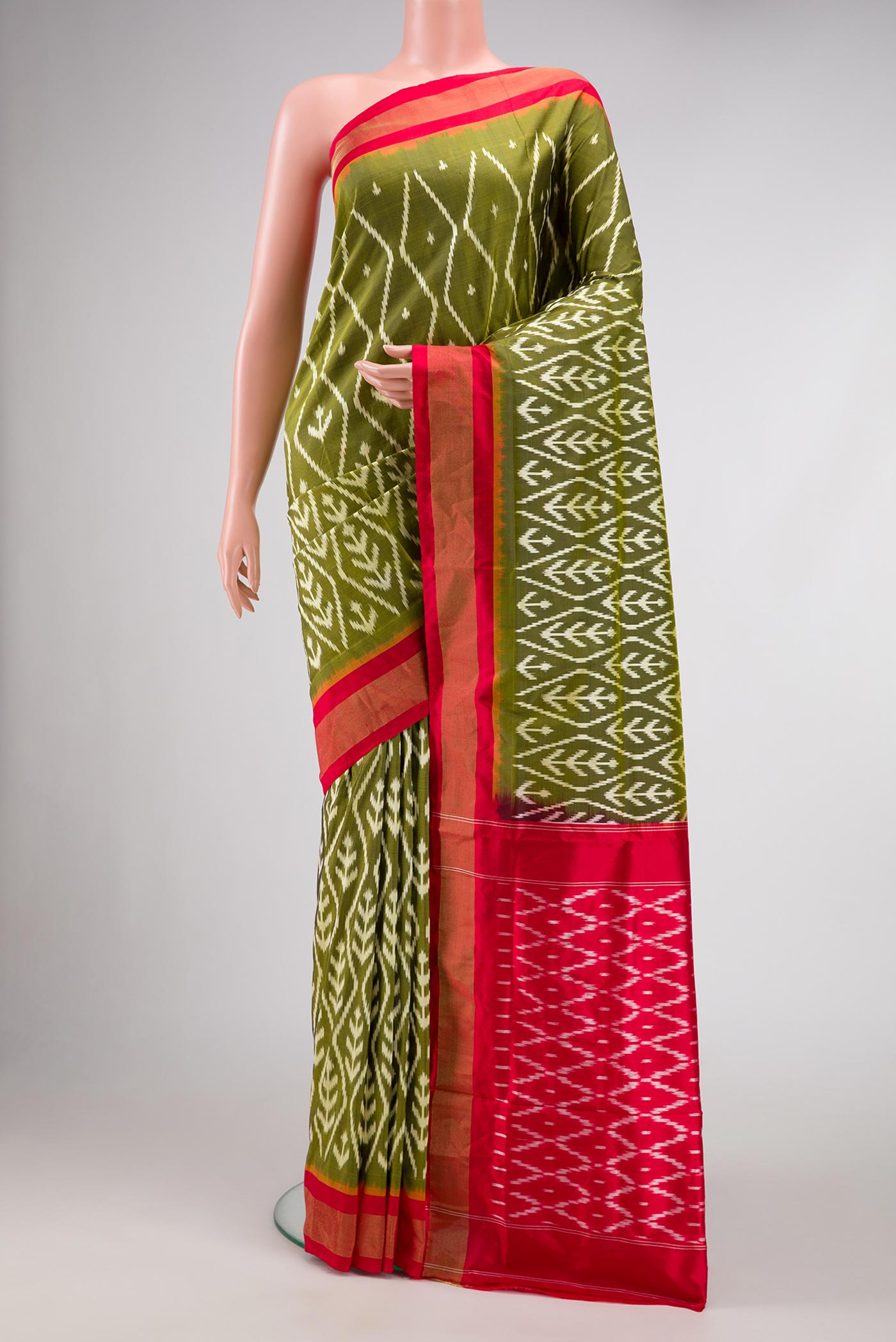 Pure Silk Pure Zari Mehandi Green Pochampally Saree with Pure Ikat on the body and Zari Border displayed on a mannequin
