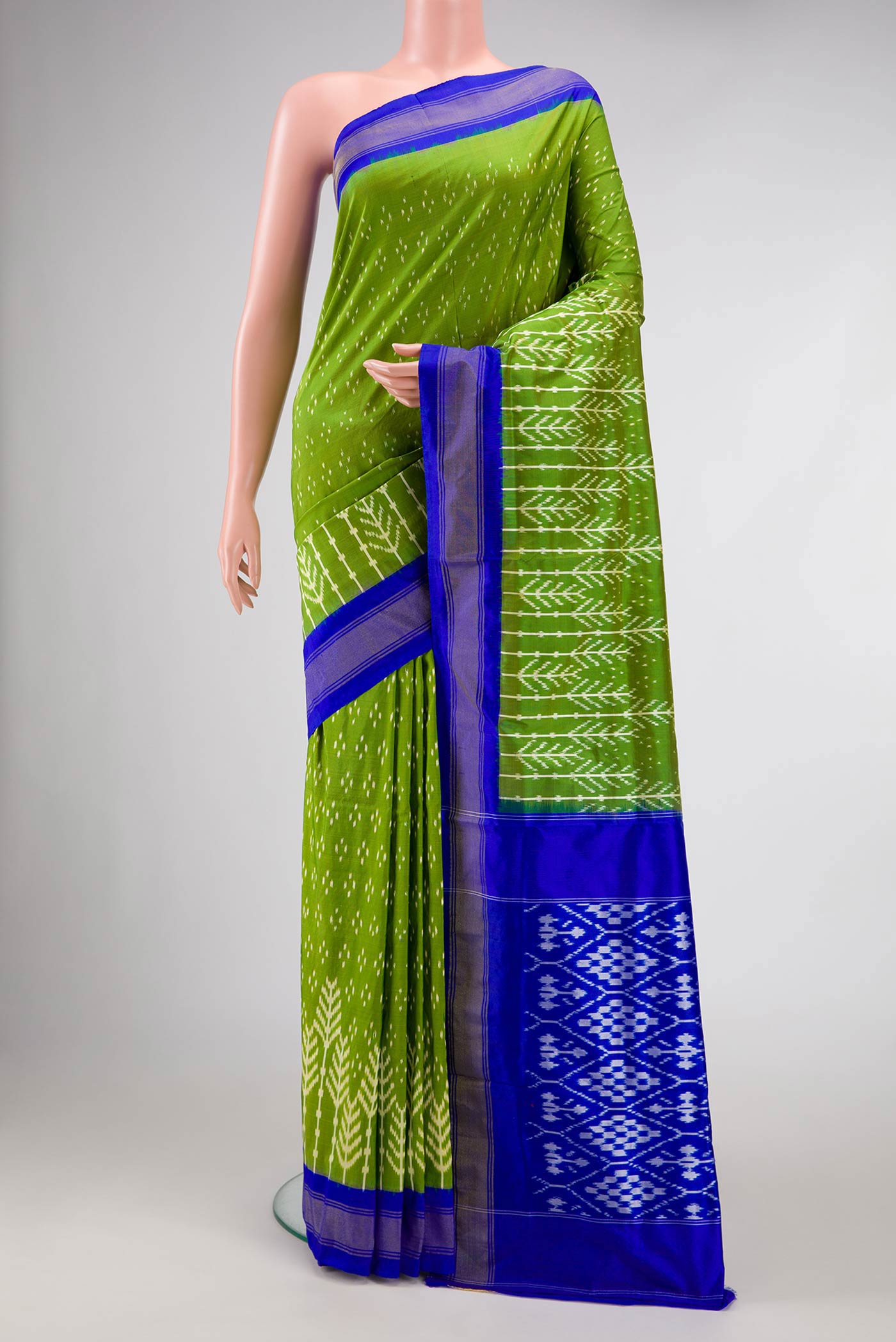 Green Dual Tone Double Ikat Saree with Ikat Print on the body and Fancy Border.  displayed on a mannequin