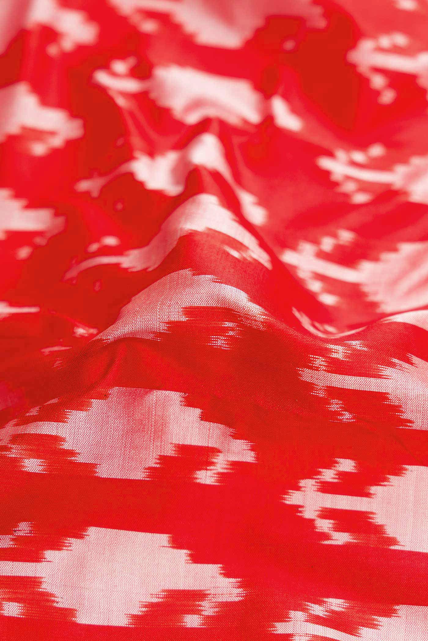 Close up of Red Pochampally Silk Saree with Pure Ikat on the body and Zari Border displaying folds
