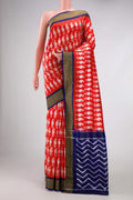 Red Pochampally Silk Saree with Pure Ikat on the body and Zari Border displayed on a mannequin