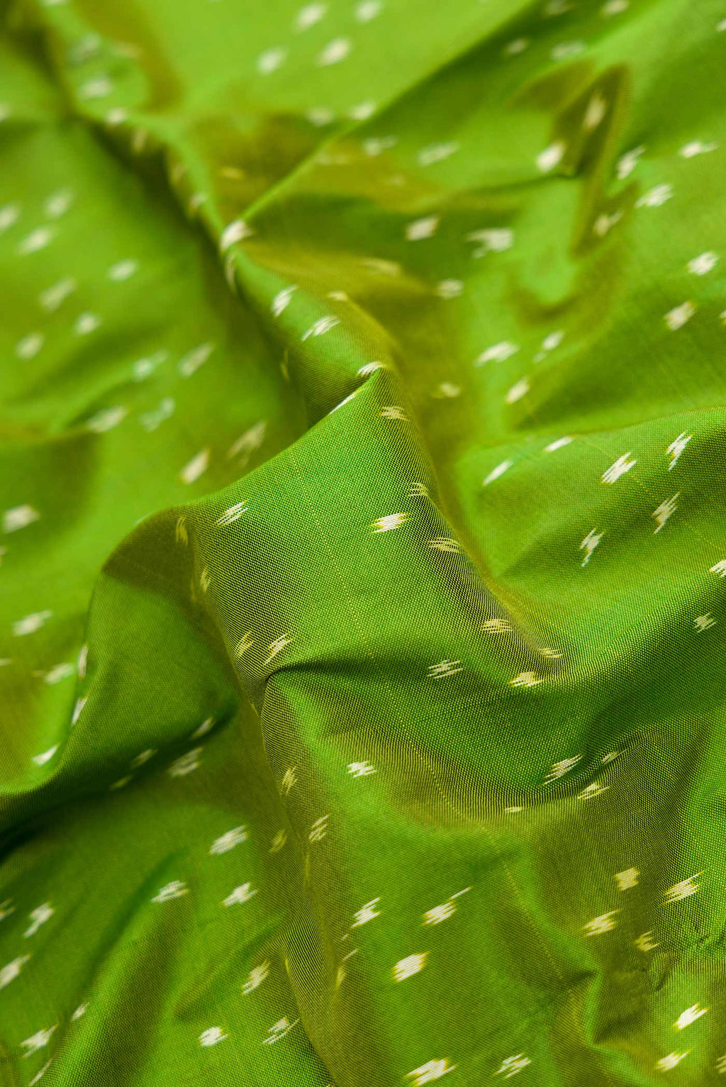 Close up of Green Pochampally Silk Saree with Pure Ikat on the body and Zari Border displaying folds