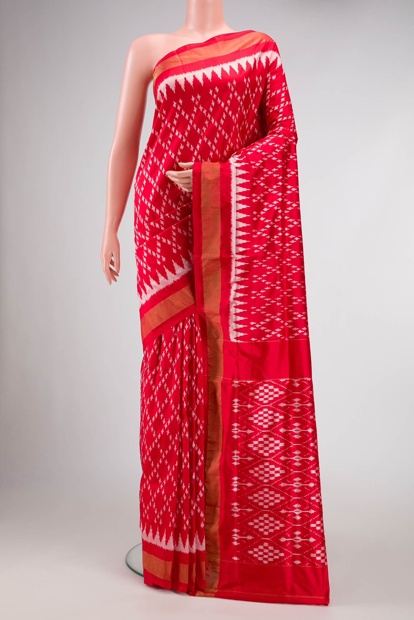Red Dual Tone Double Ikat Saree with Ikat Print on the body and Zari Border.  displayed on a mannequin