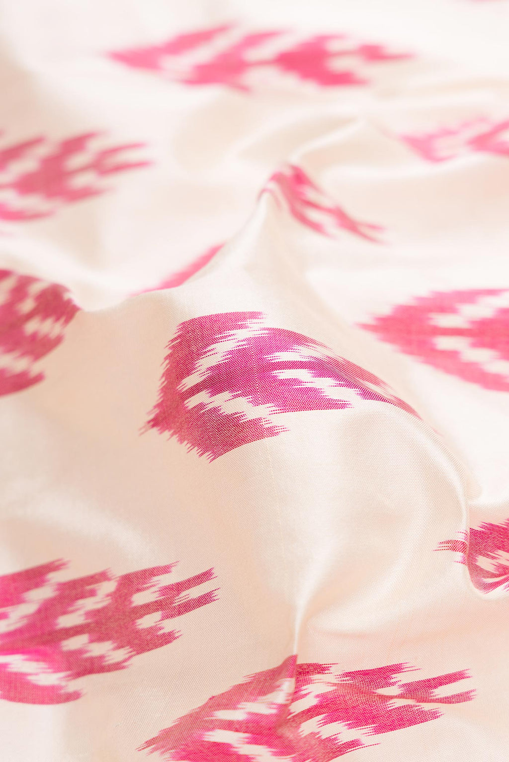 Close up of Off White Dual Tone Double Ikat Saree with Ikat Print on the body and Zari Border.  displaying folds