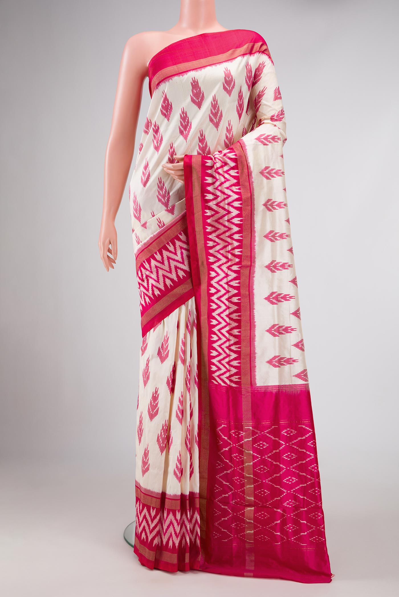 Off White Dual Tone Double Ikat Saree with Ikat Print on the body and Zari Border.  displayed on a mannequin