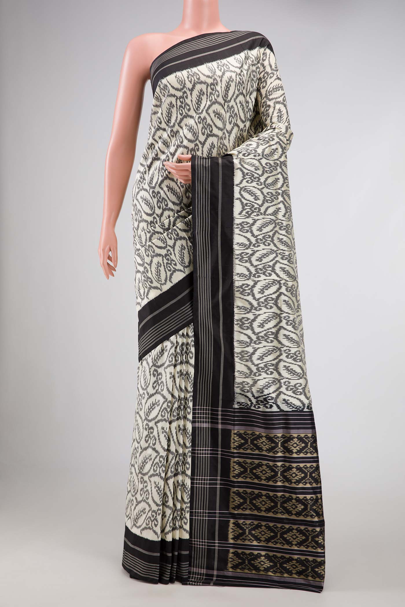 Off White Pochampally Silk Saree with Pure Ikat on the body and Plain Border displayed on a mannequin