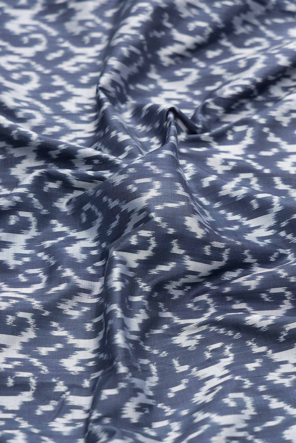 Close up of Grey Dual Tone Double Ikat Saree with Ikat Print on the body and Ikat Border displaying folds