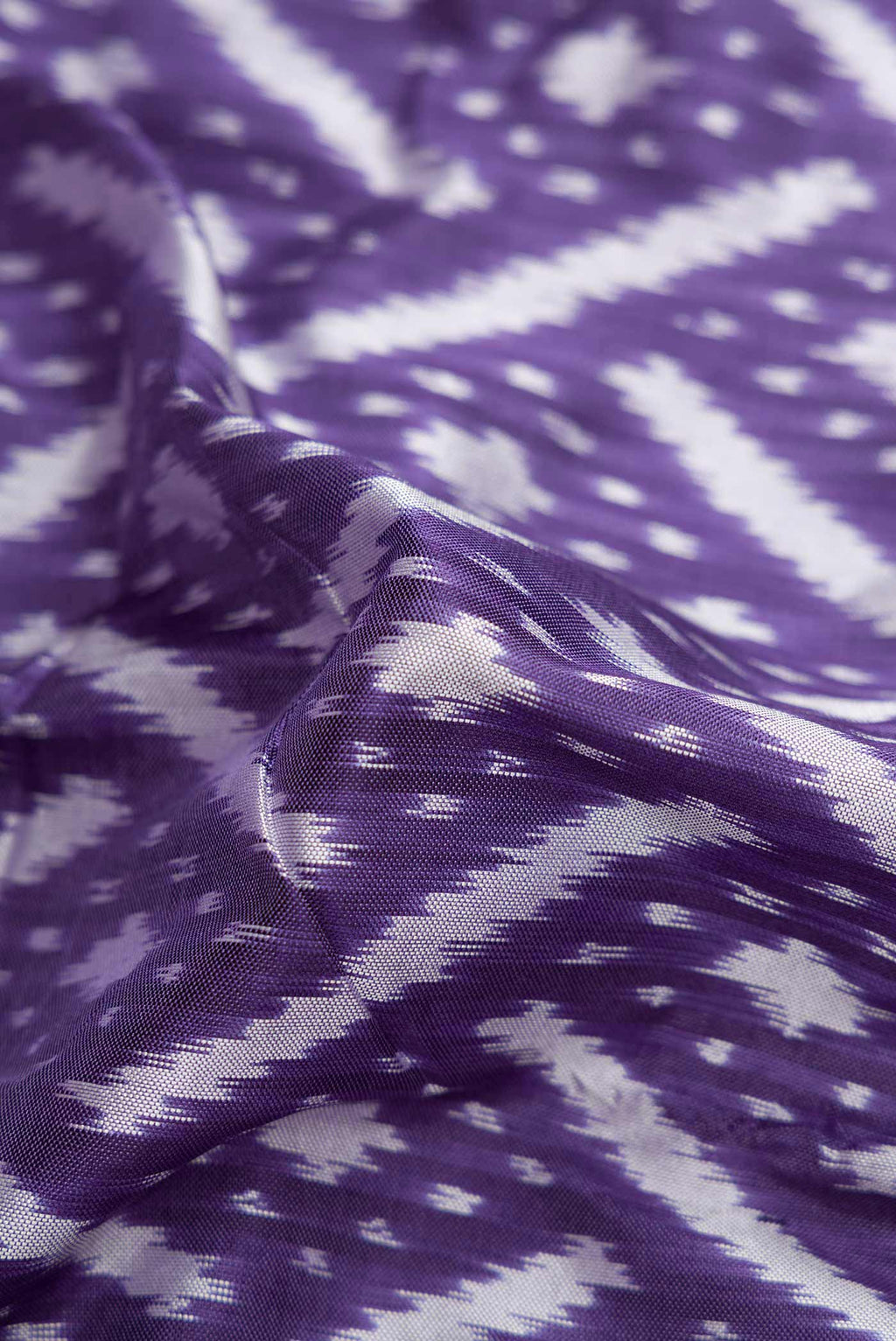 Close up of Lilac Pochampally Silk Saree with Pure Ikat on the body and Zari Border displaying folds