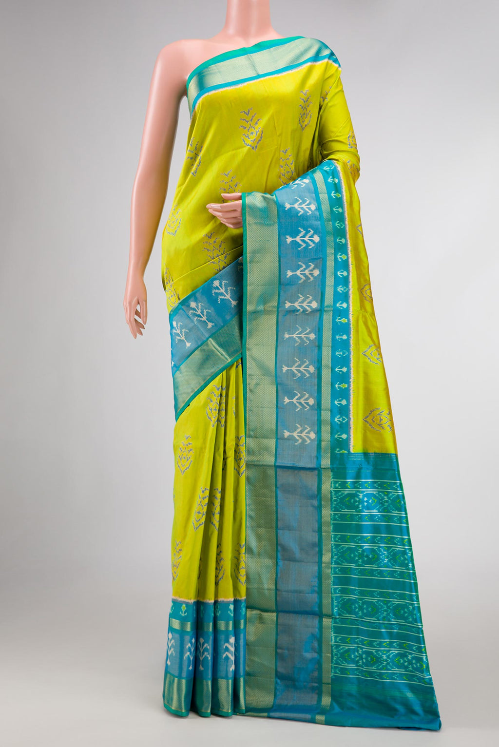 Parrot Green Dual Tone Double Ikat Saree with Ikat Print on the body and Ikat Border displayed on a mannequin