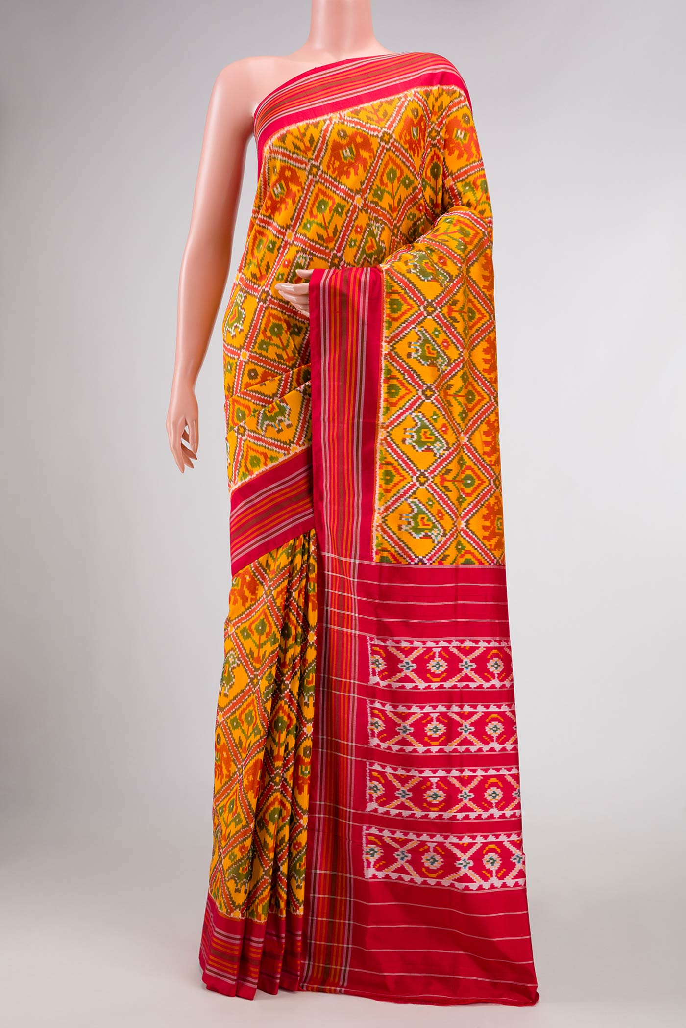 Yellow Dual Tone Double Ikat Saree with Ikat Print on the body and Thread Border displayed on a mannequin