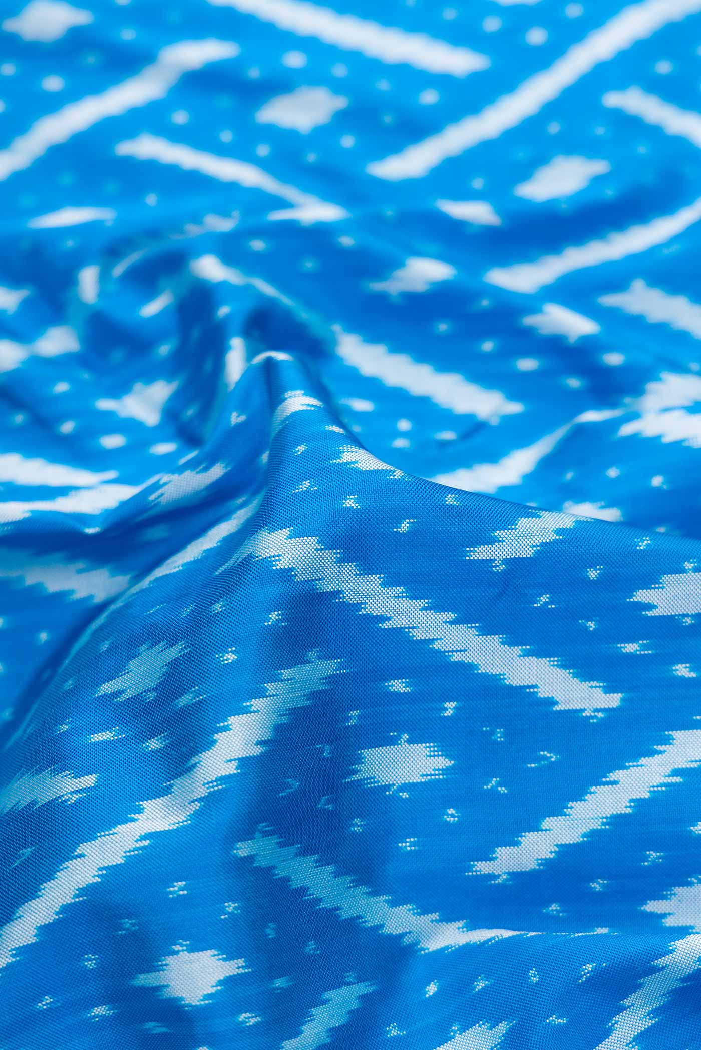 Close up of Sky Blue Pochampally Silk Saree with Pure Ikat on the body and Zari Border displaying folds