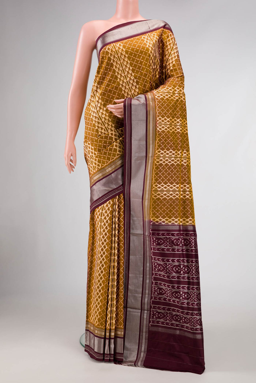Mehandi Green Dual Tone Double Ikat Saree with Ikat Print on the body and Zari Border.  displayed on a mannequin